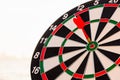 Dart arrow hit center on bullseye dartboard is target