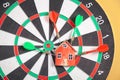 Dart arrows, house model on dartboard Royalty Free Stock Photo