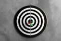 Dart board with arrows hitting target on grey Royalty Free Stock Photo