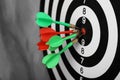 Dart board with arrows hitting target on grey wall, Royalty Free Stock Photo