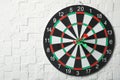Dart board with arrows hitting target on white  wall. Space for text Royalty Free Stock Photo