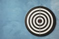 Dart board hanging on blue textured wall Royalty Free Stock Photo