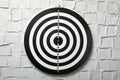 Dart board hanging on white textured Royalty Free Stock Photo