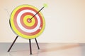 Dart board on the table and a direct hit on target Royalty Free Stock Photo