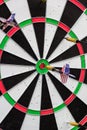 Dart in bullseye on the target with many other Darts