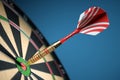 Dart in center of the target dartboard. Closeup. Royalty Free Stock Photo