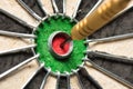 A dart hits the center of the darts board also known as