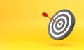 Dart hitting a target on the center on yellow background with copy space Royalty Free Stock Photo