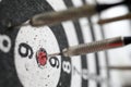 Dart shot to bull eye of dartboard among others Royalty Free Stock Photo