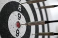 Dart shot to bull eye of dartboard among others Royalty Free Stock Photo