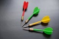 Dart sports branch, dartboard and colorful dart arrows on black ground Royalty Free Stock Photo