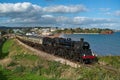 Dart valley railway in Torbay, Devon. Steam train engine pulling historic brown and beige carriages