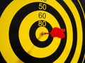 Dartboard with dart arrow in bullseye, close up Royalty Free Stock Photo