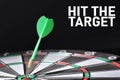 Dartboard and dart hitting the bullseye