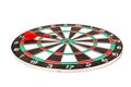 Dartboard with darts on white background, closeup. Purpose concept