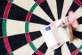 Dartboard with Steel darts and euro in it