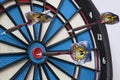 Dartboard with three darts, one hit bullseye