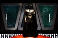 Darth Vader in front of windows viewing stars Royalty Free Stock Photo