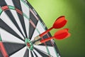 Darts arrows hitting the target center on a green background Royalty Free Stock Photo