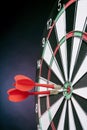 Darts arrows hitting the target center on a purple background Royalty Free Stock Photo