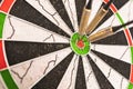 Darts arrows in the target center. Dart in bulls eye of dartboard