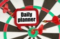 On the darts are darts and a sign with the inscription - Daily planner