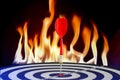 Darts embroidered on dartboard with fire flames. Royalty Free Stock Photo