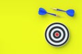 Darts game on yellow background. Dart and bullseye. Top view Royalty Free Stock Photo