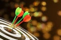 Darts hitting target on board against blurred background Royalty Free Stock Photo