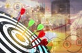 Darts hitting target on board, graph illustration, view of cityscape and sky at sunset Royalty Free Stock Photo