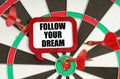 On the darts are darts and a sign with the inscription - FOLLOW YOUR DREAM Royalty Free Stock Photo