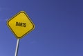 Darts - yellow sign with blue sky background