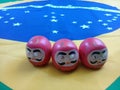 Daruma dolls on a Brazilian flag Royalty Free Stock Photo