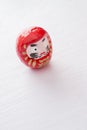 One eyed Daruma on white surface