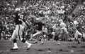 Daryle Lamonica chased by Steve DeLong of the San Diego Chargers