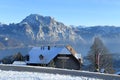 The Gmundnerberg Haus on the Gmundnerberg in winter with the Traunstein and Traunsee in the background, Austria, Europe