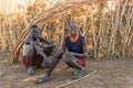 Dasanesh young mans resting in shadow of hut, Omorate, Omo Valley, Ethiopia people diversity