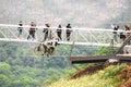 Dashbashi, Georgia- 19th JUne, 2022: staff help male rider on zip bike over valley in beautiful caucasus mountains