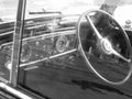 Dashboard of a classic vintage car with reflections . Nostalgia concept . Black and white photo