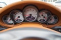 Dashboard is covered in beige genuine leather of a sports car with instruments speedometer and tachometer displays are highlighted Royalty Free Stock Photo