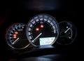 Dashboard instruments like odometer, speedometer, tachometer and control LEDs of modern car at night Royalty Free Stock Photo