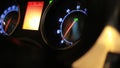 Dashboard of moving car. Tachometer arrow revving in moving car