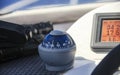 Dashboard with nautical compass, navigator and binoculars on yacht