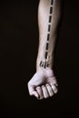 Dashed line and word life in a forearm