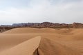 Dasht-e Kavir desert sand dunes with mountains on. Royalty Free Stock Photo