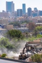 Dasma, Kuwait - 4th October 2019: A bulldozer demolishing an old house on the corner of Routes 30 and 2 spreading dust in the air