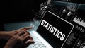 Data Analysis with Digital Interface Featuring Statistics on Laptop Screen with Hands Typing in Dark Environment Royalty Free Stock Photo