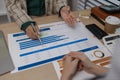 data analysis staff are helping to check data in various documents before summarizing and presenting them to the meeting, two Royalty Free Stock Photo