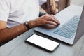 Data backup files to online cloud storage using wifi connection concept. Male hands using laptop and smartphone with blank screen