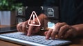 Data Breach Concept with Alert Symbol on Screen While Typing on Keyboard representing Security Concerns Royalty Free Stock Photo